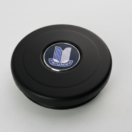 An alloy horn button, black anodised with a Triumph Badge